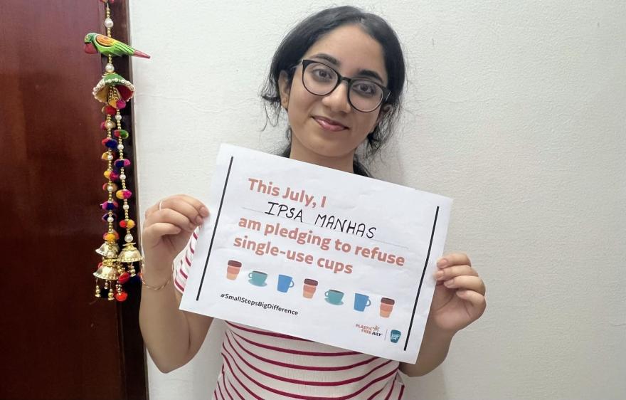 Person holding up a Plastic Free July pledge