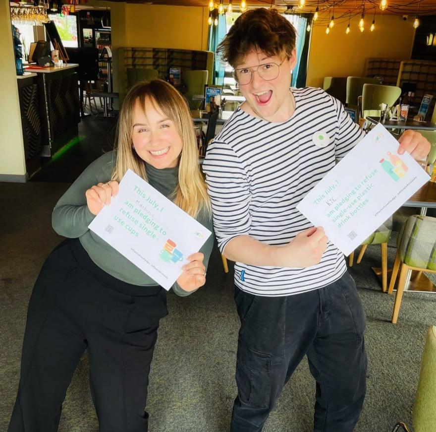 People holding up Plastic Free July pledges