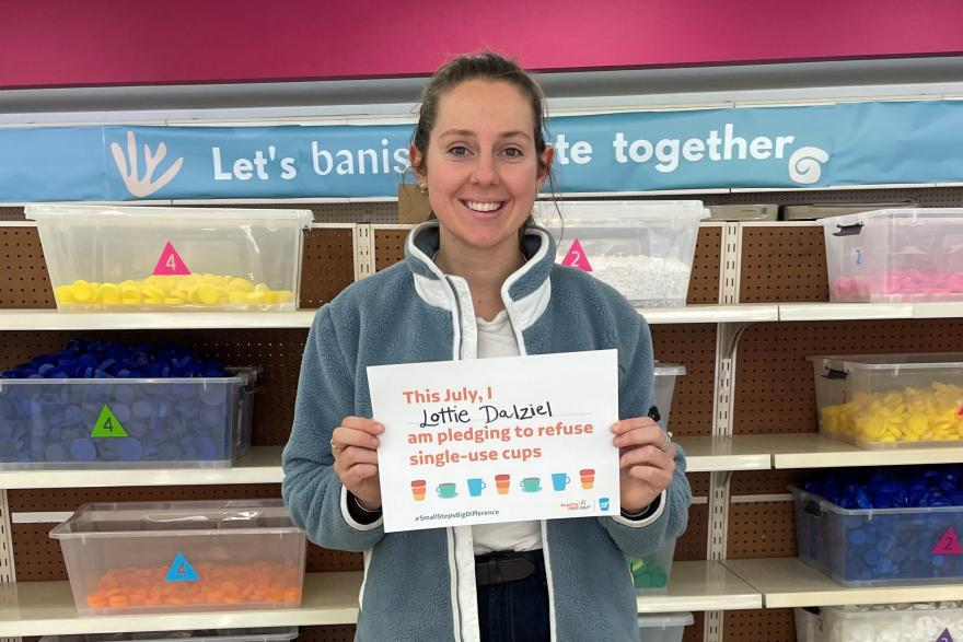 Person holding up a Plastic Free July pledge