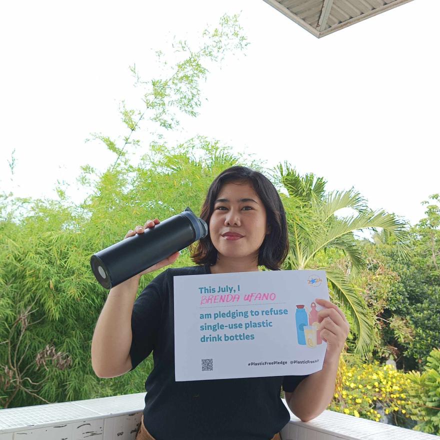 Person holding up a Plastic Free July pledge