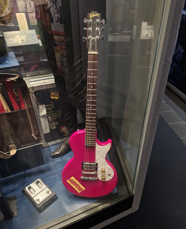 Dom Mariani's red Gibson Melody Maker guitar in the Reflections Gallery display cabinet.