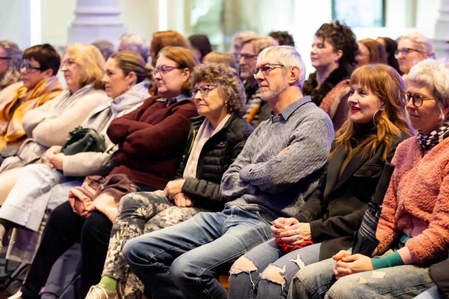 a crowd of people seated and listening
