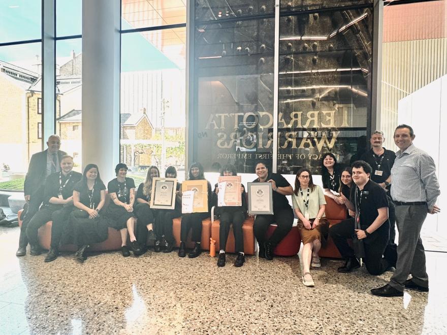 The Visitor Service Officers Team holding the award certificates Infront of the WA Museum Booela Bardip reception
