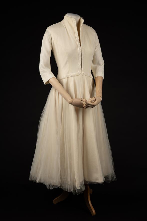 Vintage cream wedding dress with tulle skirt and long sleeves.