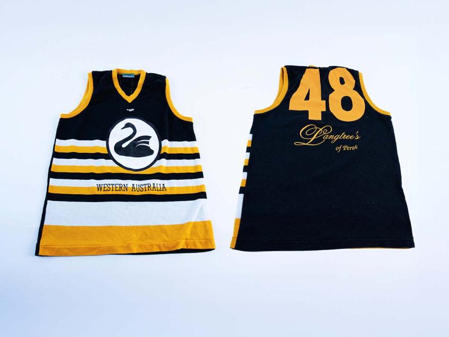 Front and back of a football shirt with navy, yellow and white stripes. On the front is a black swan emblem, with Western Australia written. On the back is number 48 with a logo for Langtree's of Perth.