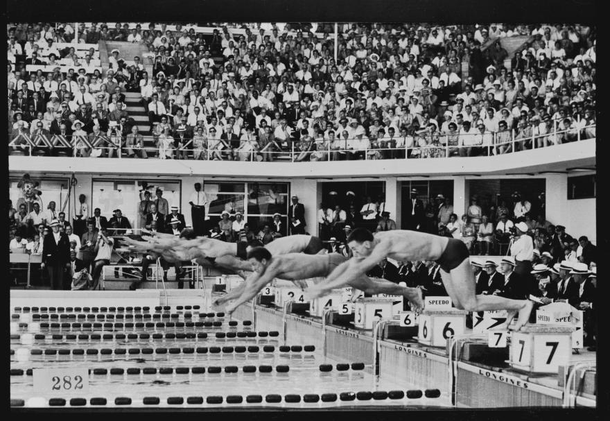 Men diving into a pool