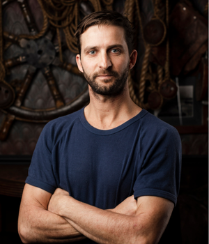 Man in navy tshirt with arms crossed