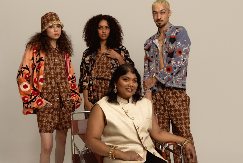 Lady sitting in chair with three models posing behind her