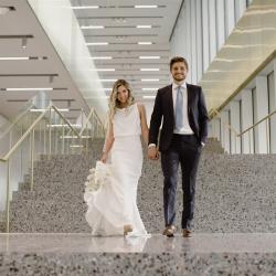 Bride and groom standing side by side on the stairs