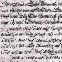 Close-up of an aged handwritten historical manuscript with faded ink, dense cursive text, and visible wear on parchment.