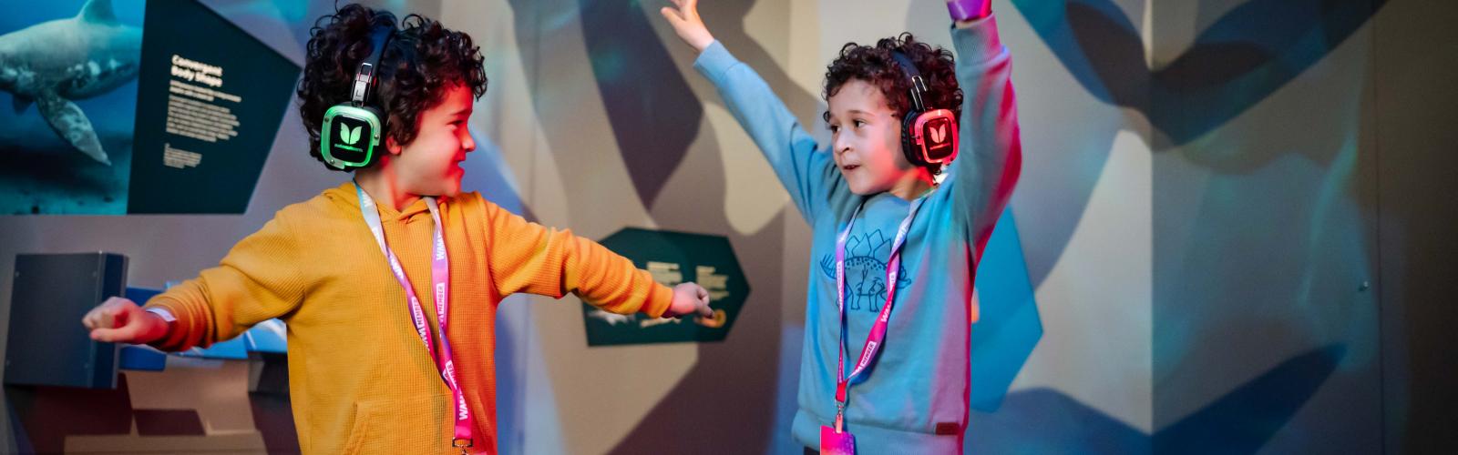 Image of two children dancing with silent disco headphones