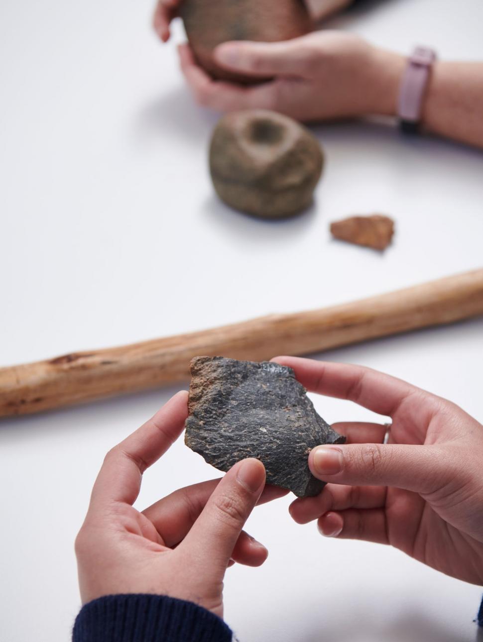 Hands holding stone tools