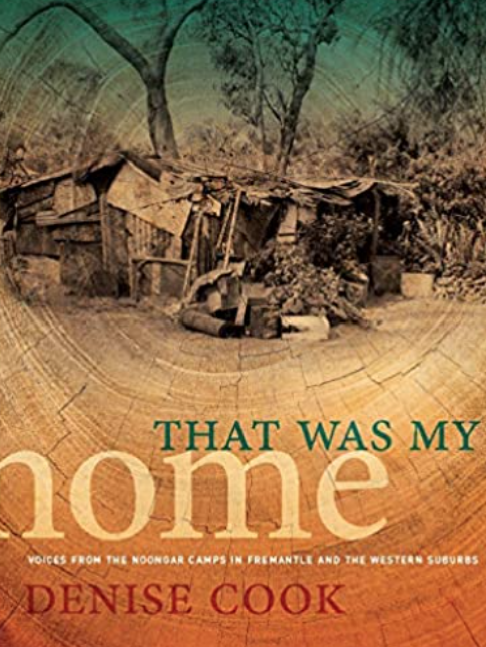 An image of the cover of a book 'That was my home' by Denise Cook, featuring a photograph of a camp surrounded by trees