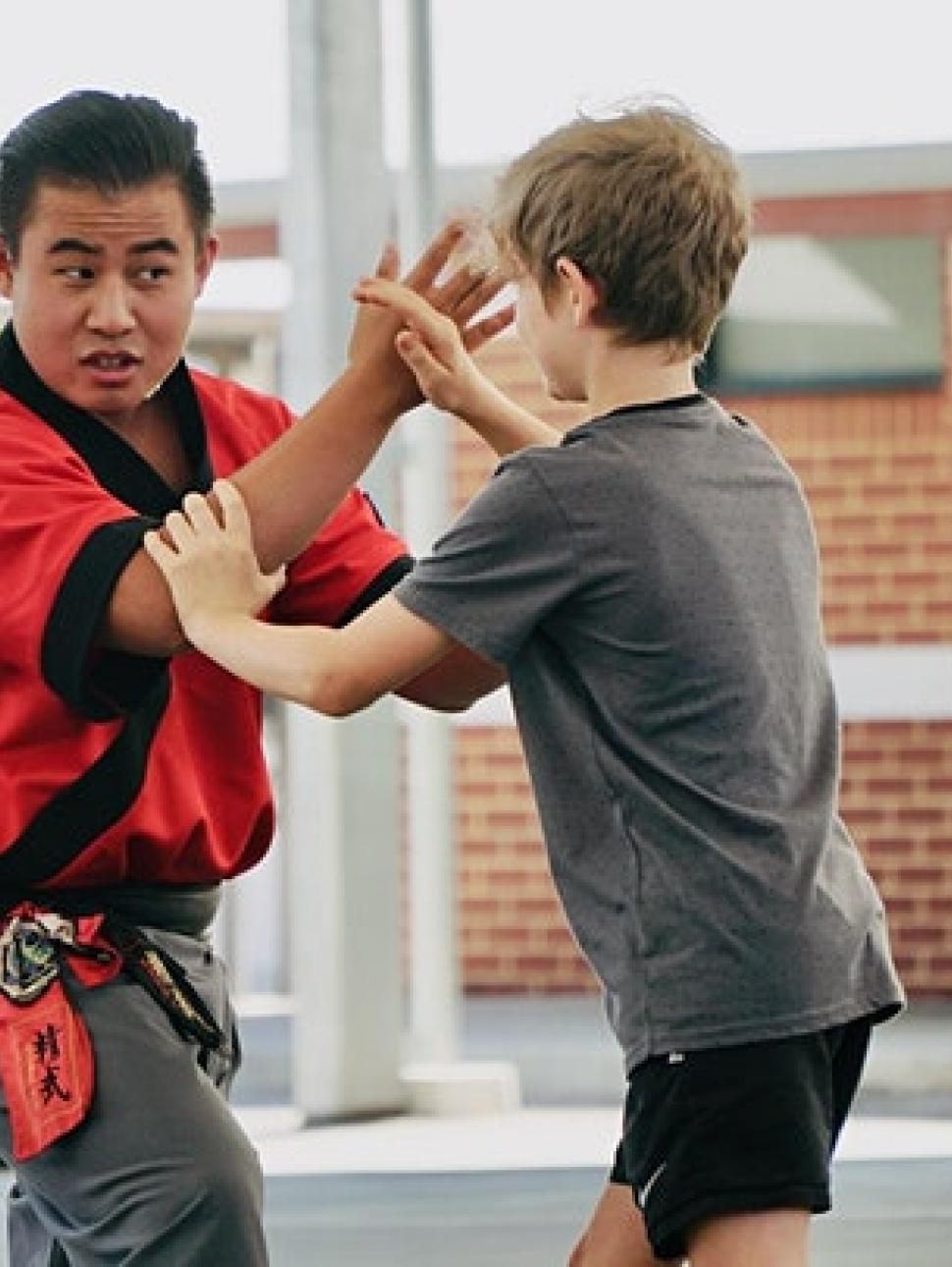 Master and child practicing Play Fu