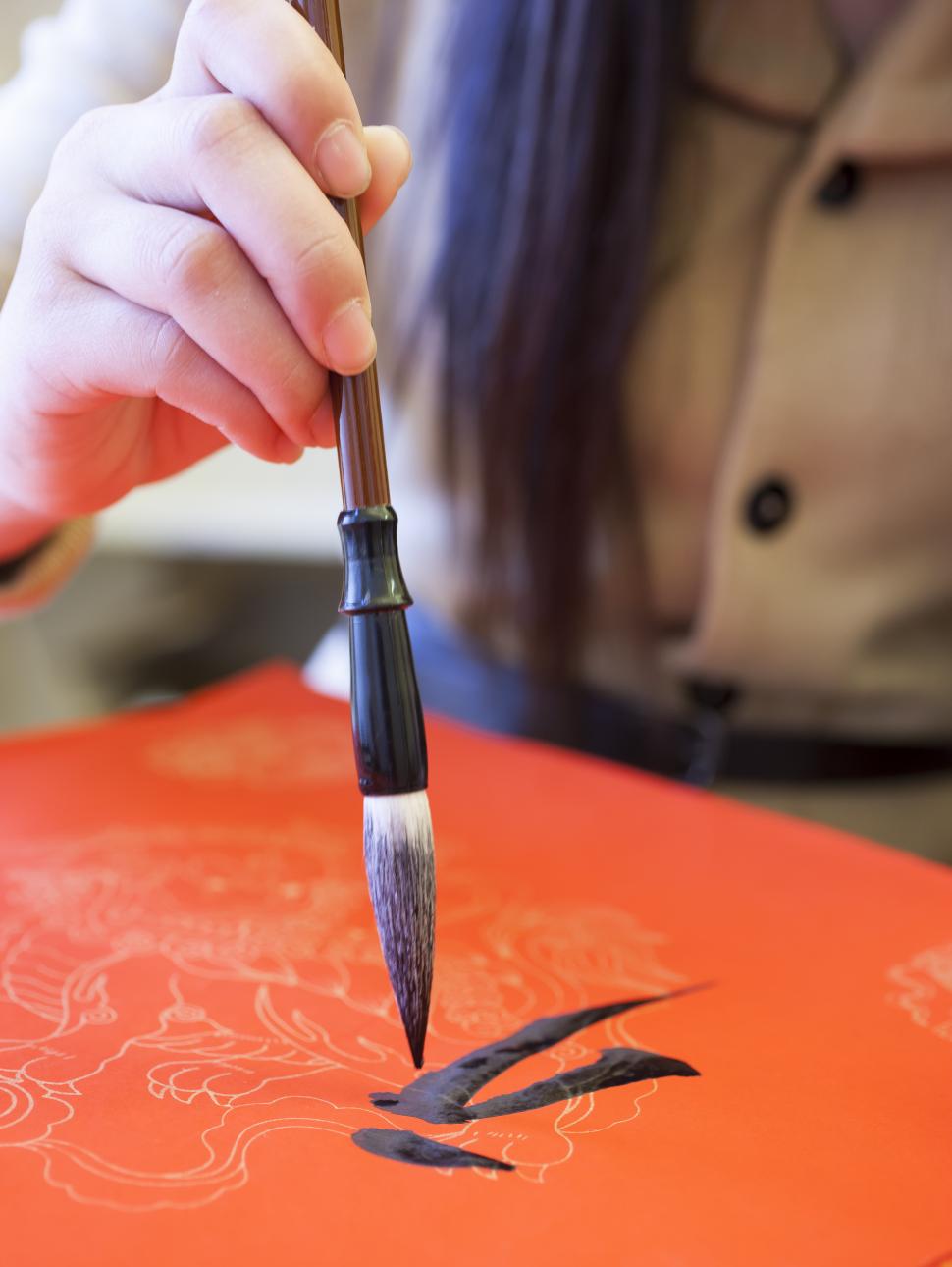 Lady drawing Chinese characters