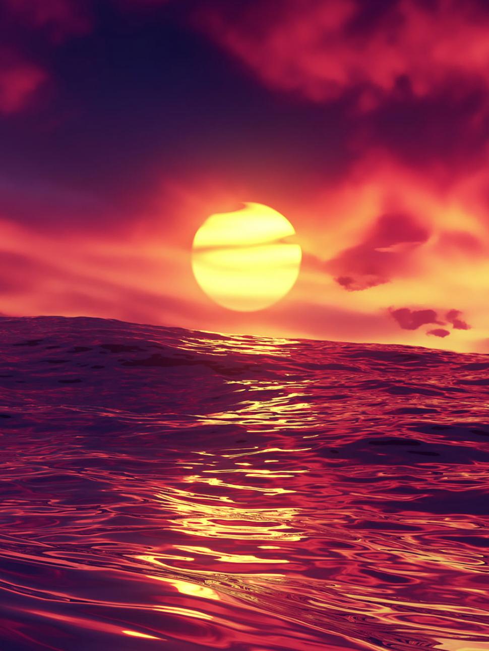 A vibrant photograph of the sun setting over the ocean