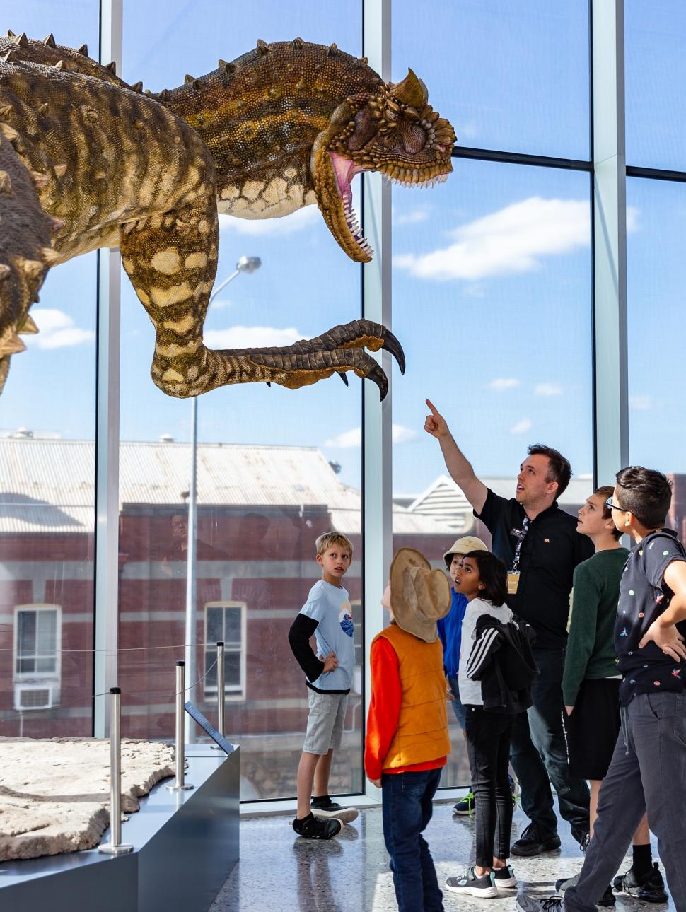 A tour group looking at one of the Museum's dinosaurs