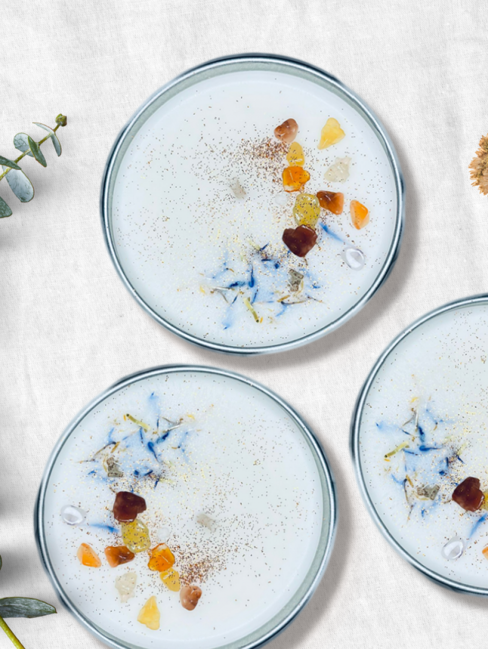 Image of three candles decorated with petals