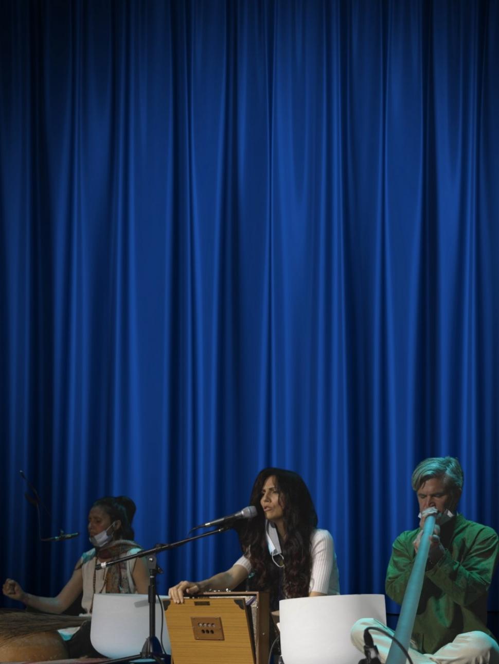 Three musicians playing instruments