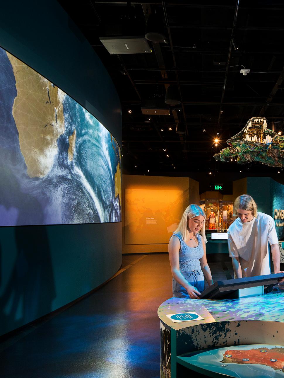 People interacting with display in Connections Gallery