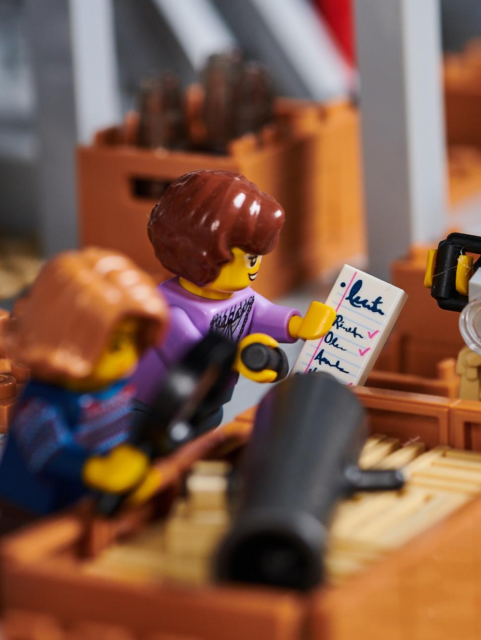 Archaeologist LEGO figures examine, photograph and catalogue boxes of artefacts