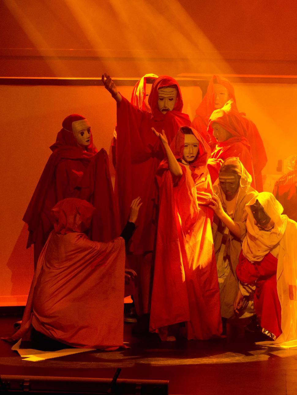 Photograph of a group of children acting in an Ancient Greek theatre production.