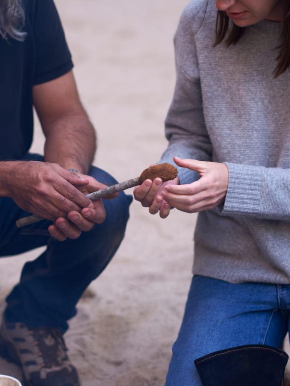 Photograph of two people crafting a taap knife.