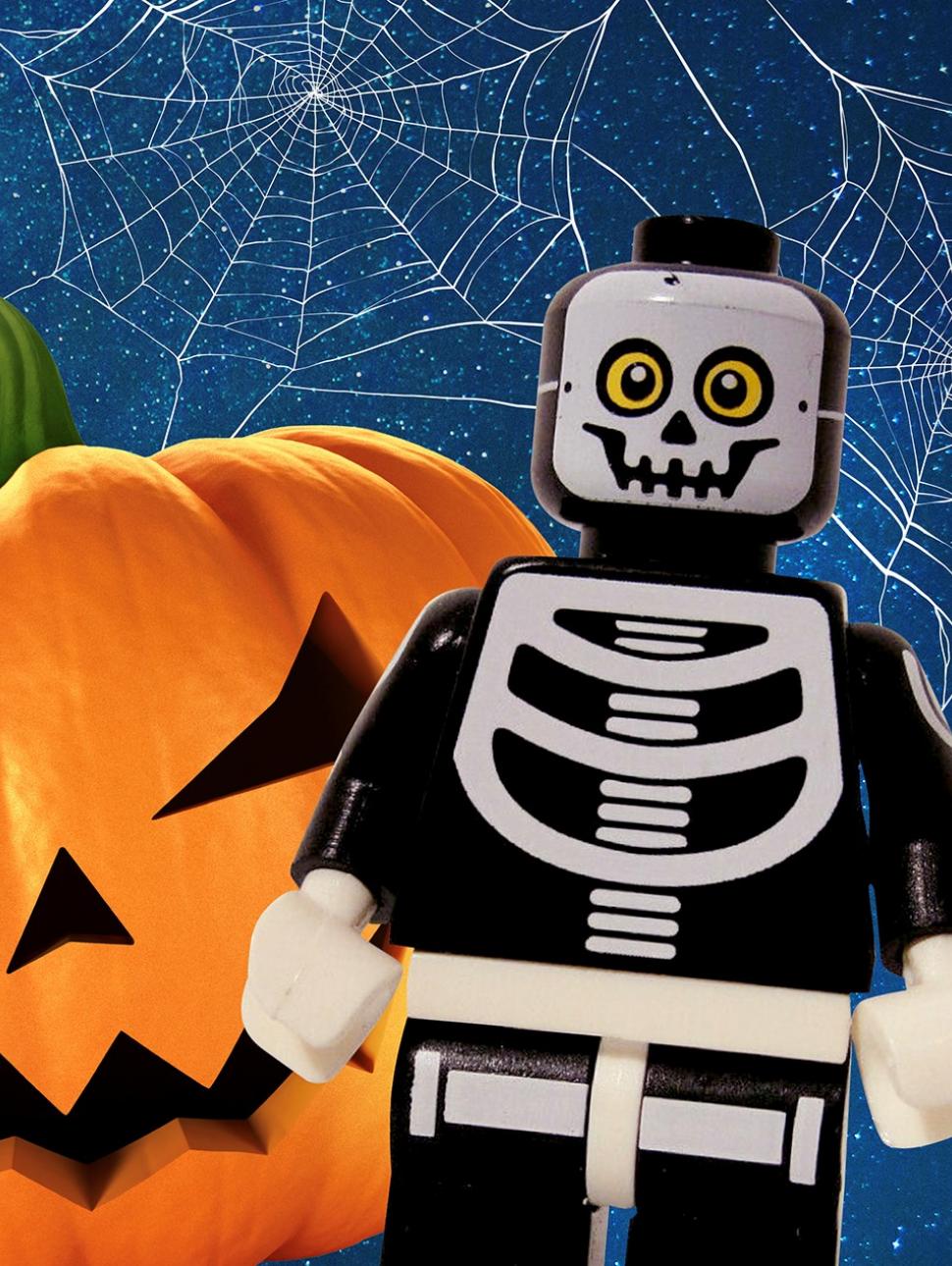 An image of a Halloween LEGO minifig character next to a carved out pumpkin