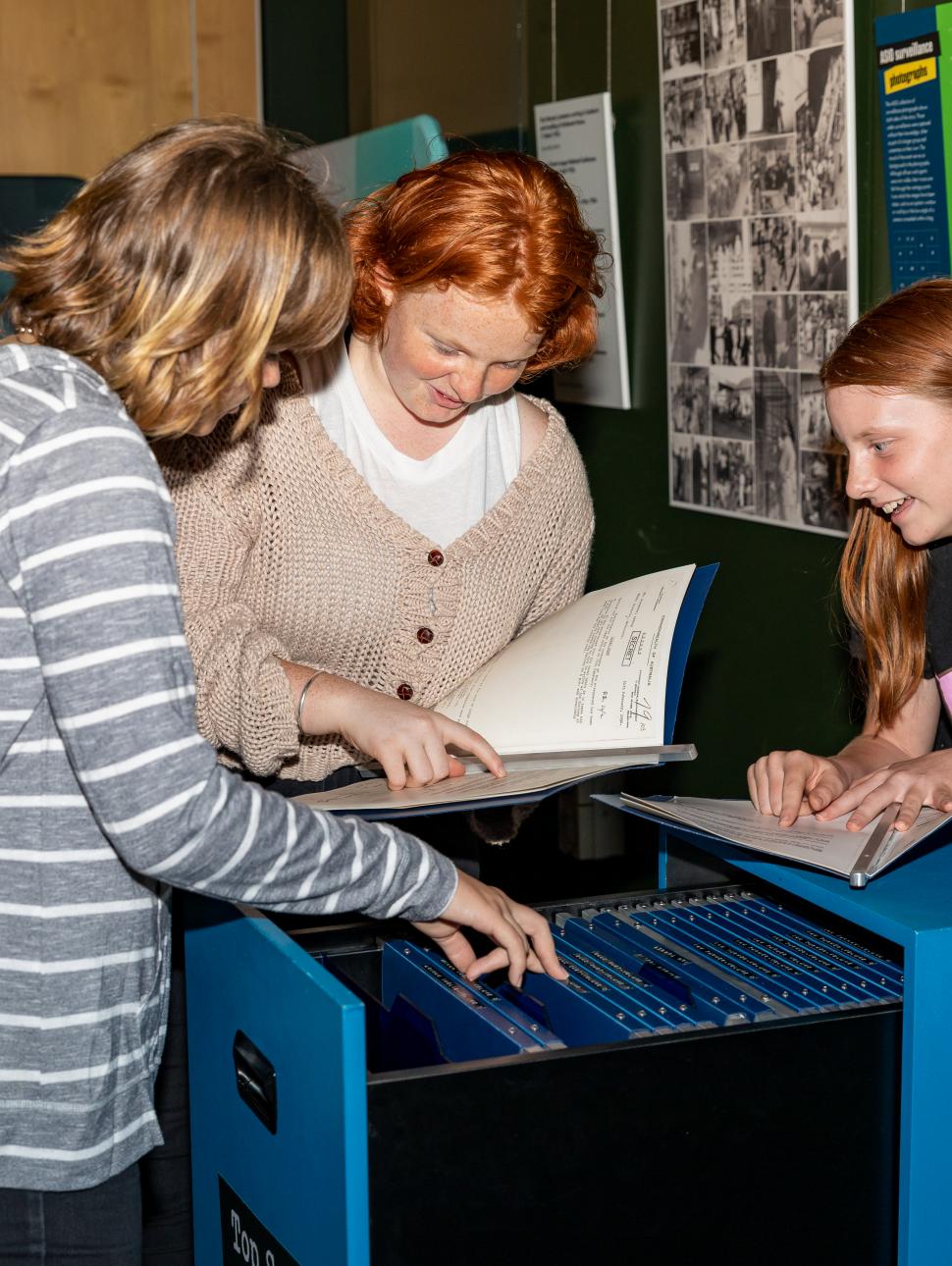 An image of three children investigating clues during a Spy School session