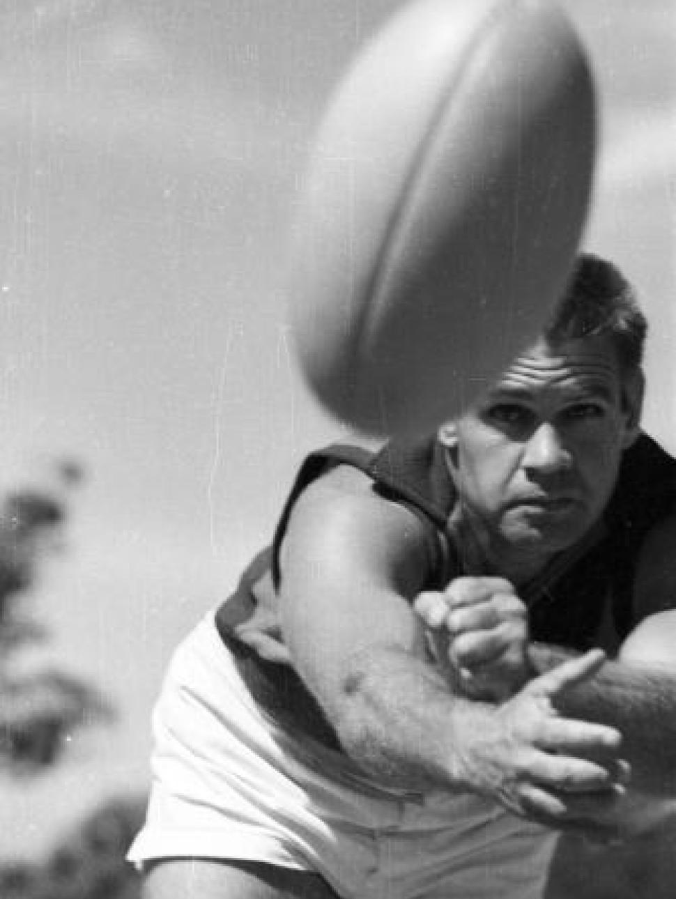 Polly Farmer, with football. Black and white.