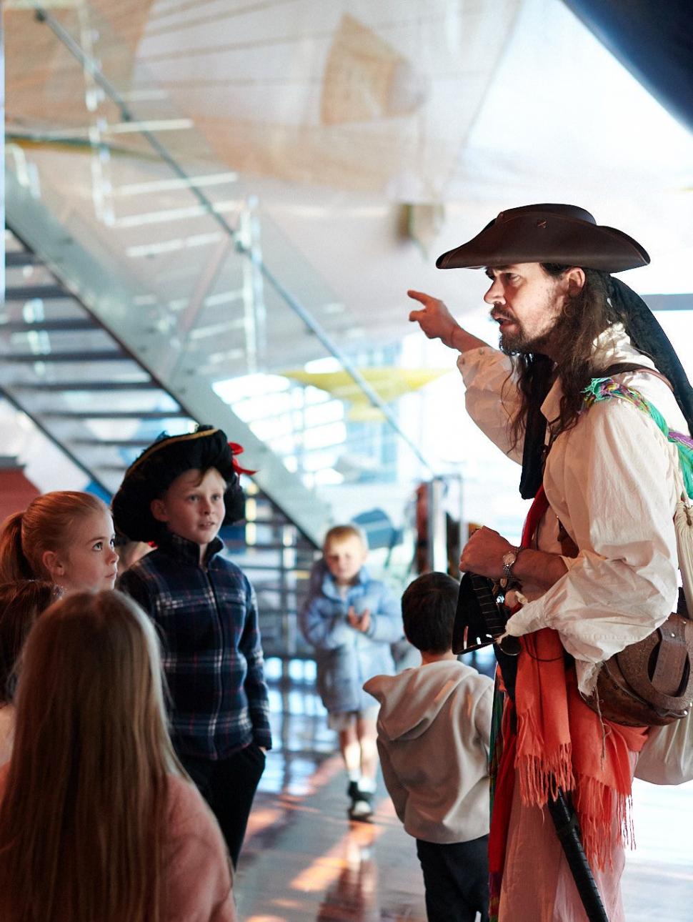 Young people participating in an interactive storytelling session with Captain Boots .