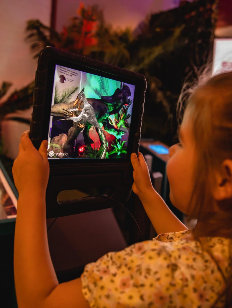 Young girl plays with a screen