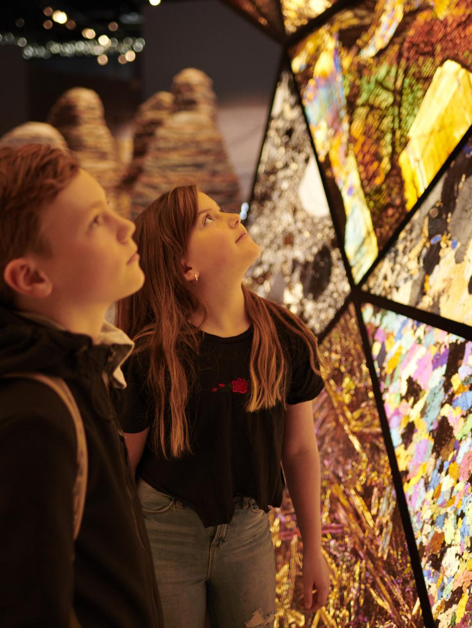 Two school students explore the Origins gallery.