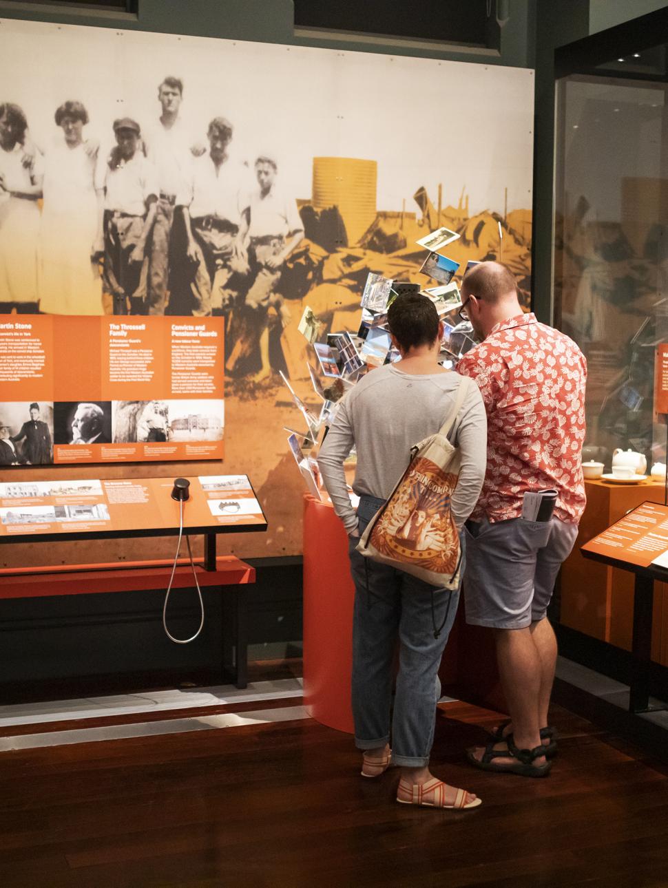 Image of visitors on a tour in the Reflections Gallery at WA Museum