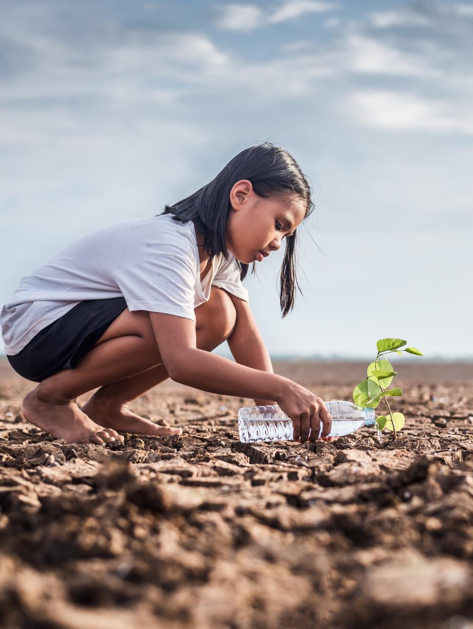 girl crouching on scorched earth