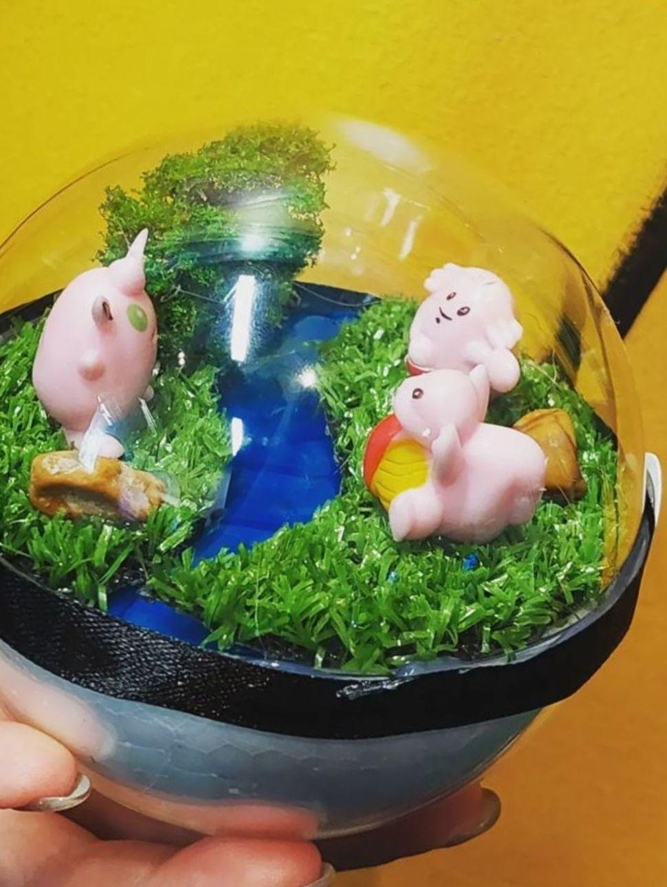 Image of a Pokeroma globe with pokemon figures inside.