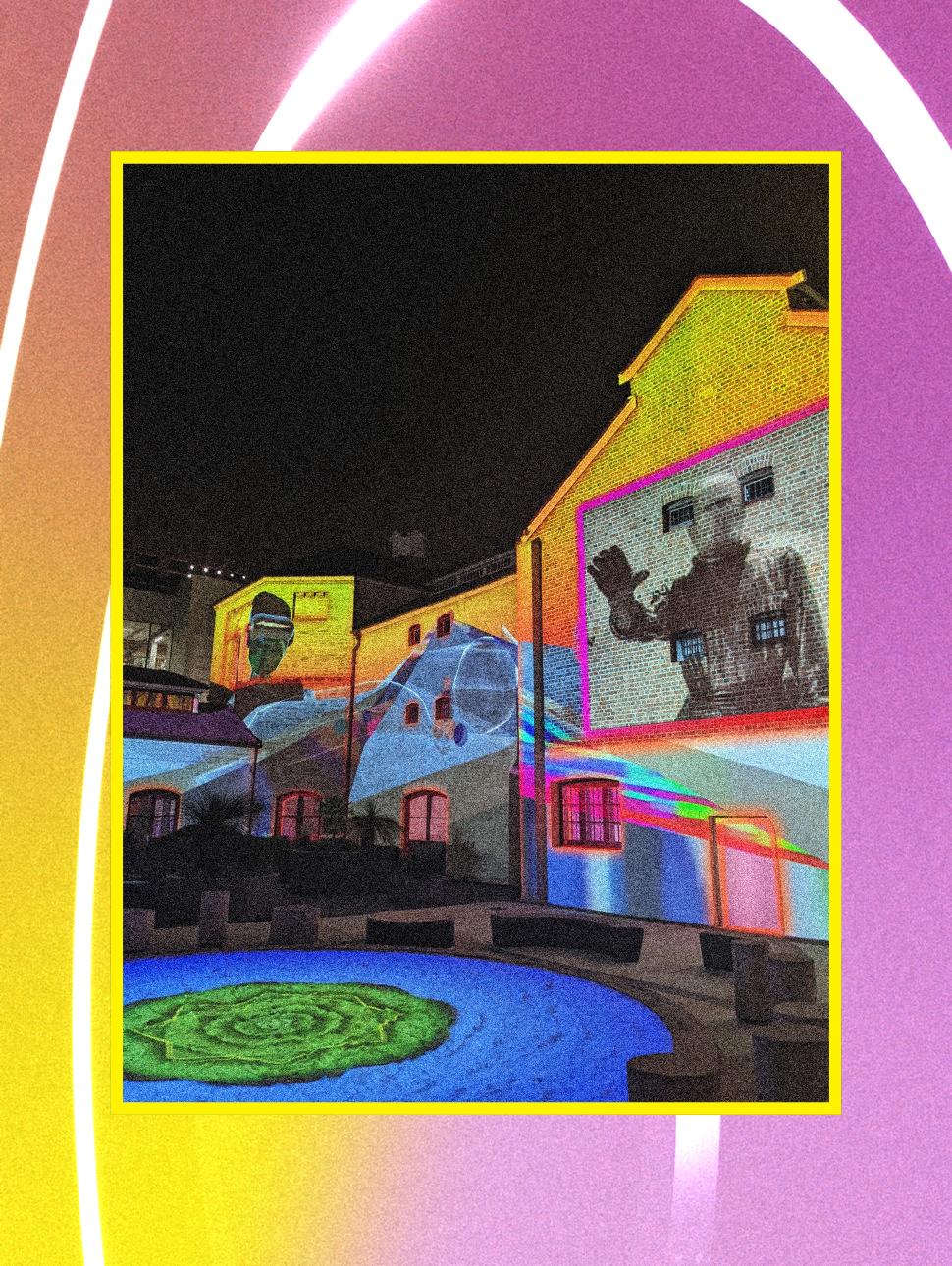 Light projections on the Old Gaol surround by a neon purple and yellow rectangle