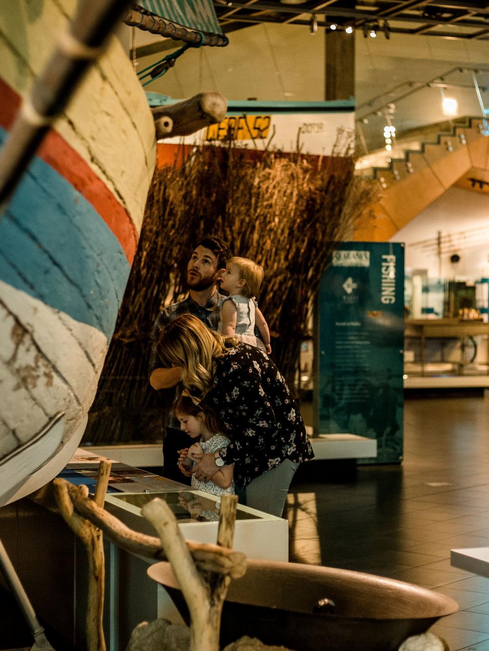 Family exploring museum wooden boat