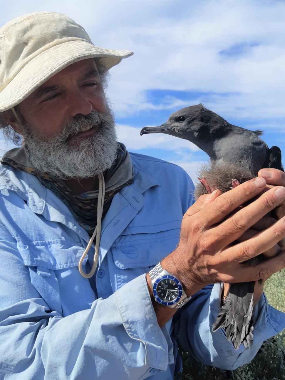 Image of speaker Chris Surman holding a bird