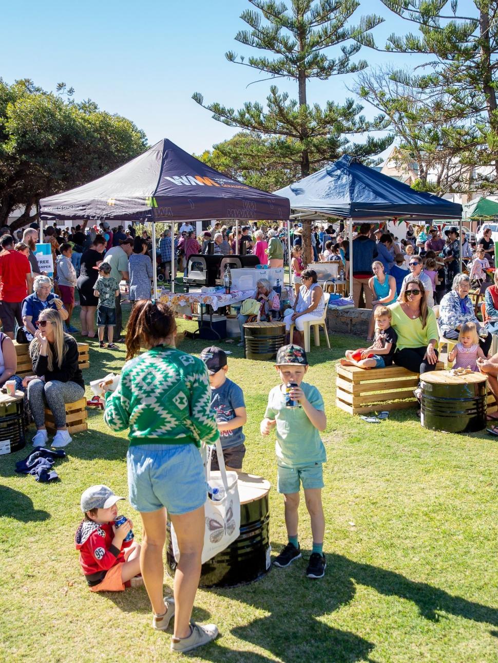 Image of a group of people sitting under tents celebrating WA Day. 