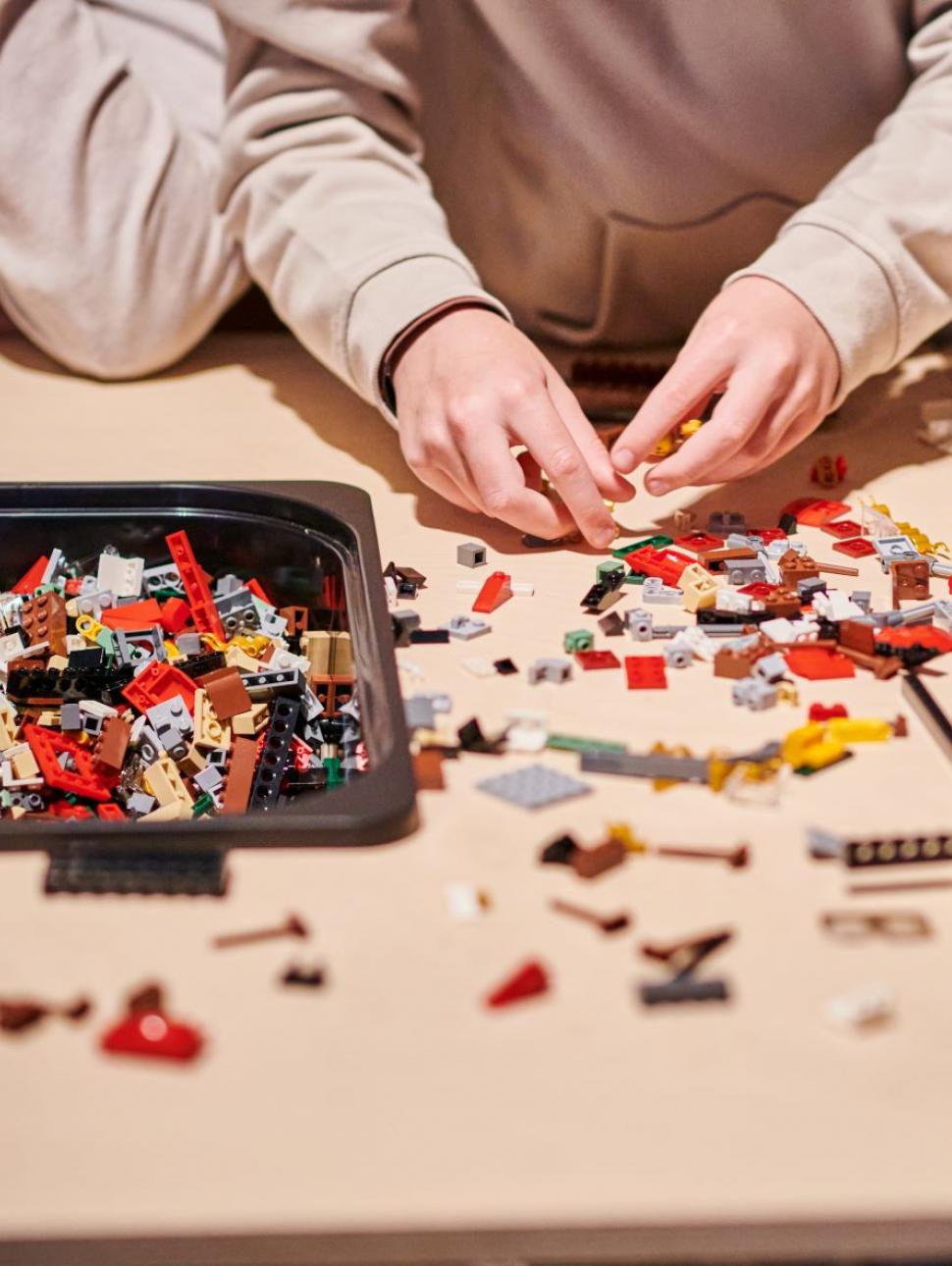 Hands playing with lego