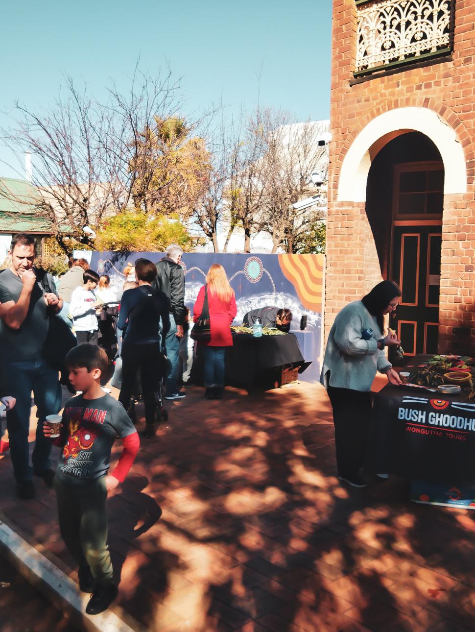 Image of a group of people attending an event outside the Museum of Goldfields