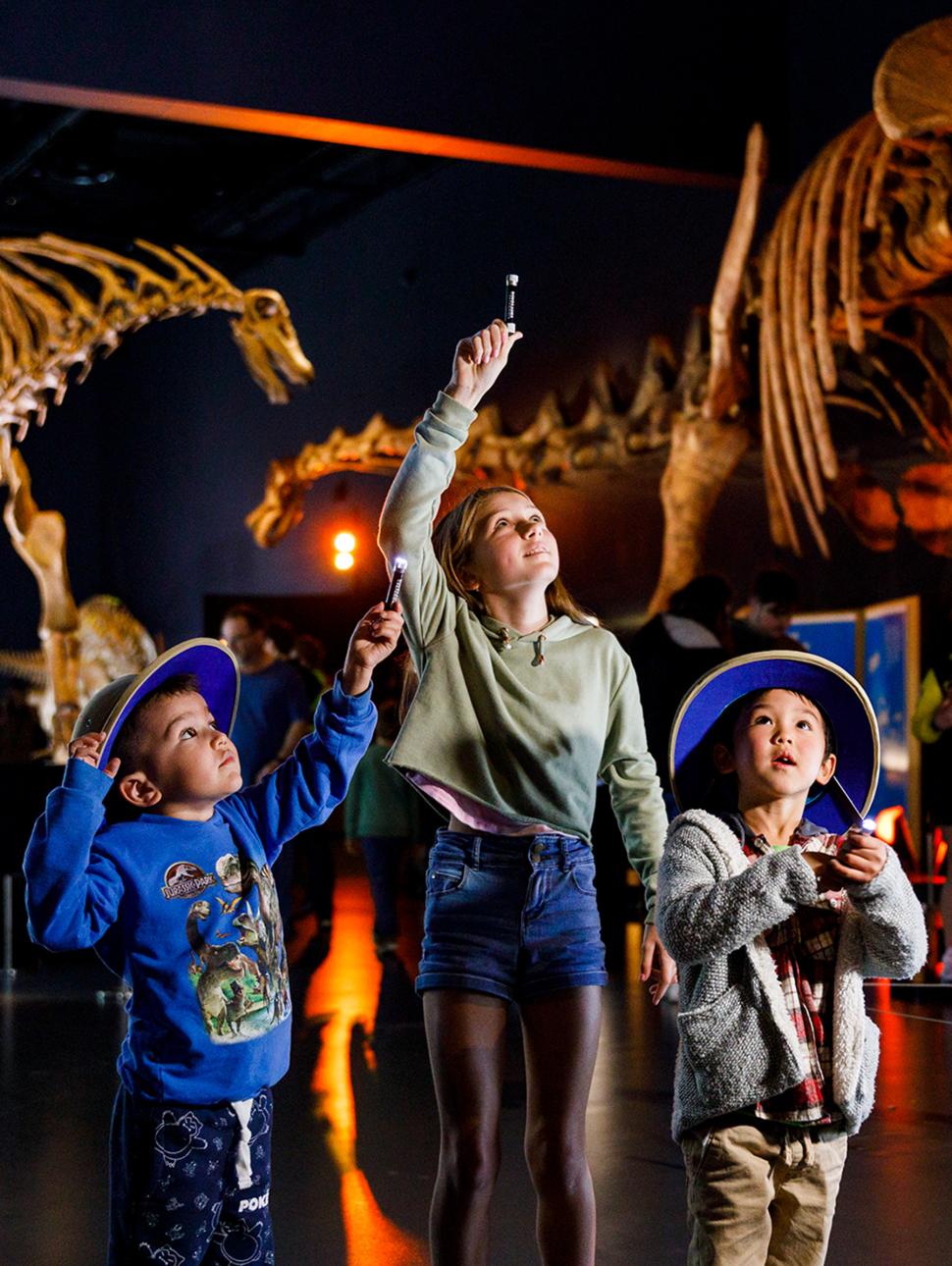 Image of three kids exploring the Dinosaurs of Patagonia exhibition 