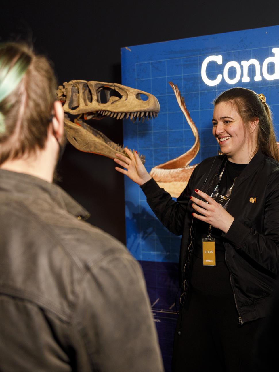 Image of a WAM Boola Bardip staff member taking visitors through the Dinosaurs of Patagonia exhibition.