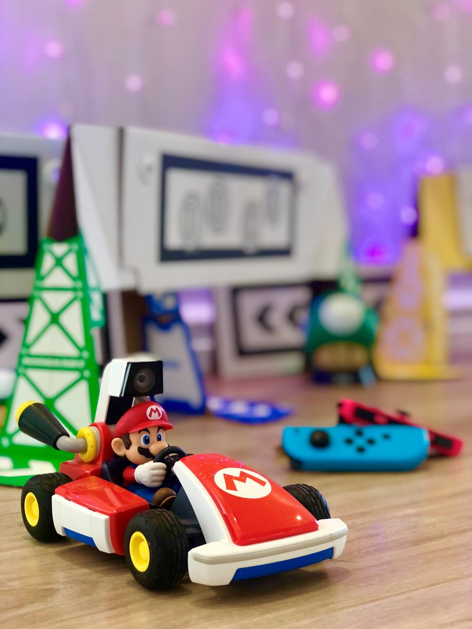 Image shows a red care with the character Mario sitting in it.