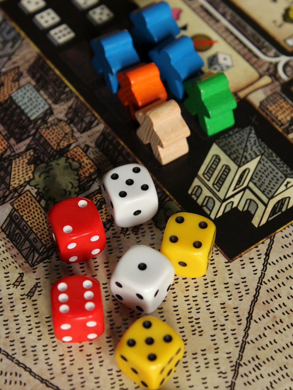 Photographs shows a number of coloured die used for board games