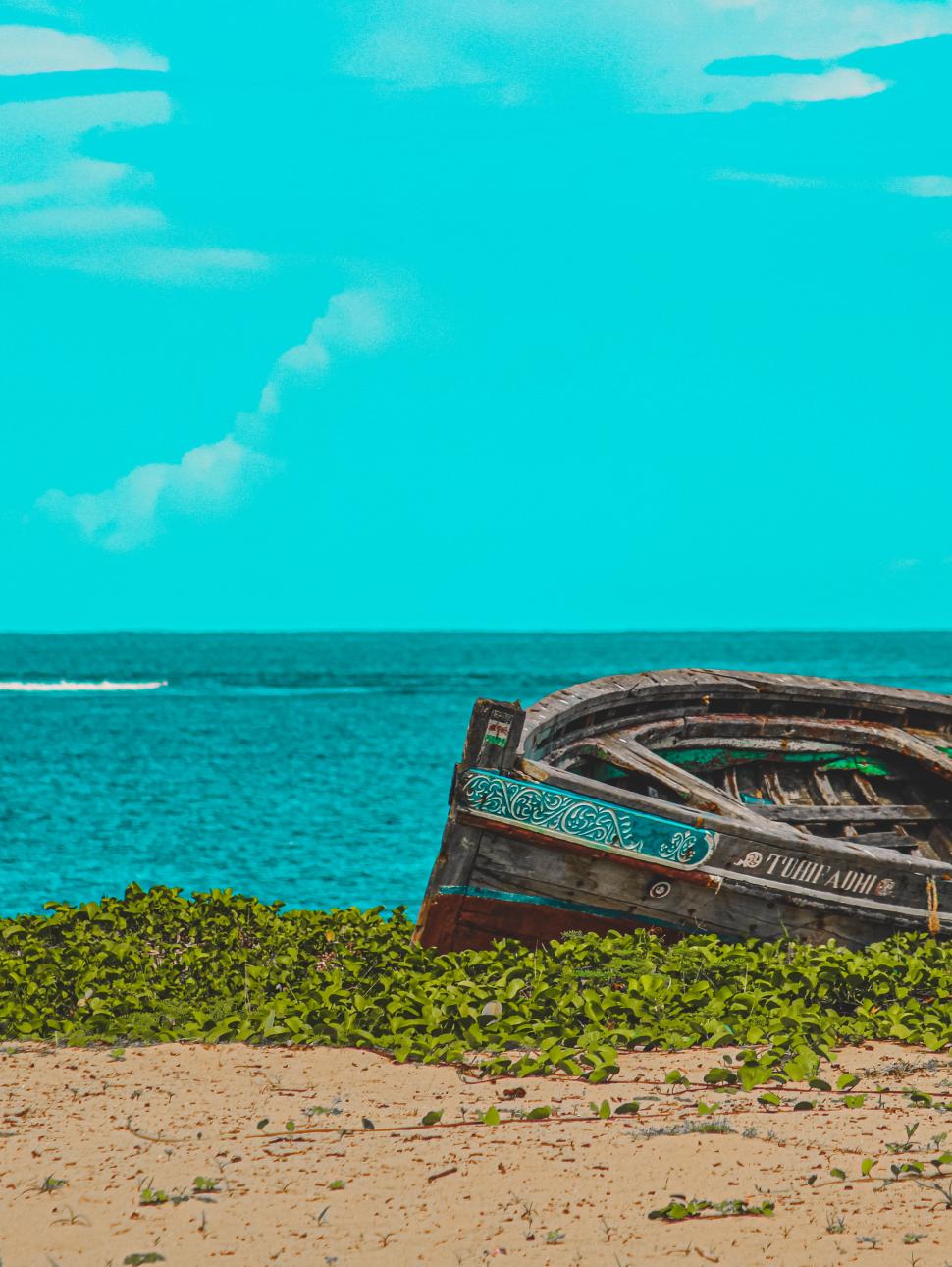 Image of shipwrecked boat on deserted shore. 