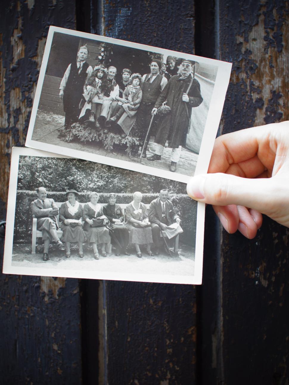 Image of two old black-and-white photographs being held together.