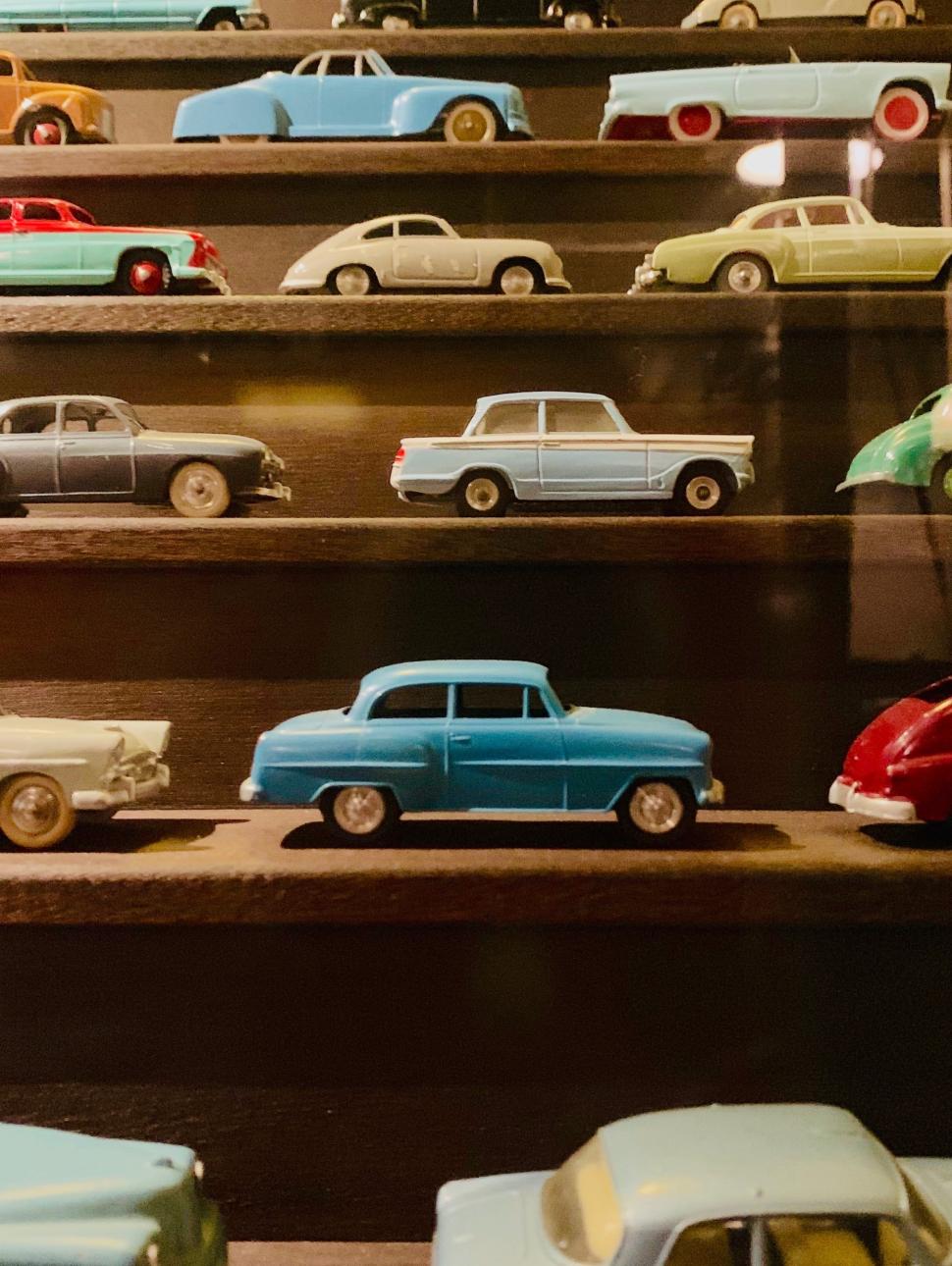 Rows of old metal play cars on a wooden staircase 