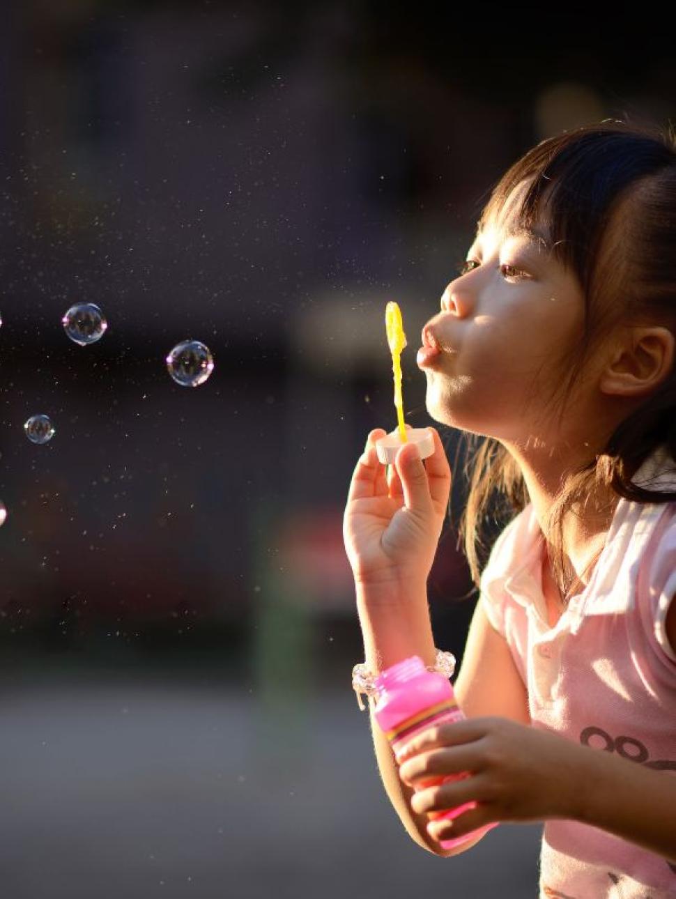 Image of a child blowing bubbles 